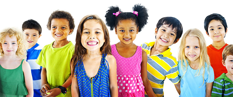 The image shows a diverse group of children posing together with bright smiles, wearing colorful clothing.